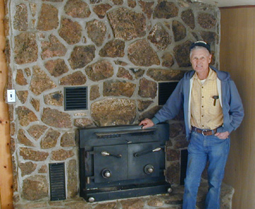 Mr. Tomsick in front of the Fireplace insert he designed and constructed.......
