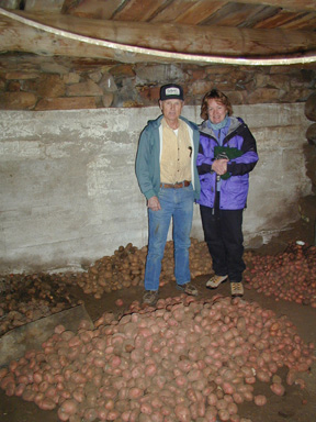 Mr. Tomsick fills Marty's hat with Potatoes grown on the Ranch......