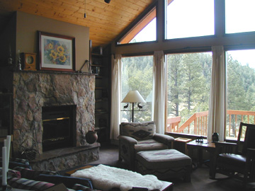One of the 2 Fireplaces in the home...... Large windows offer magnificent views of the Sangre de Cristo mountain range.......